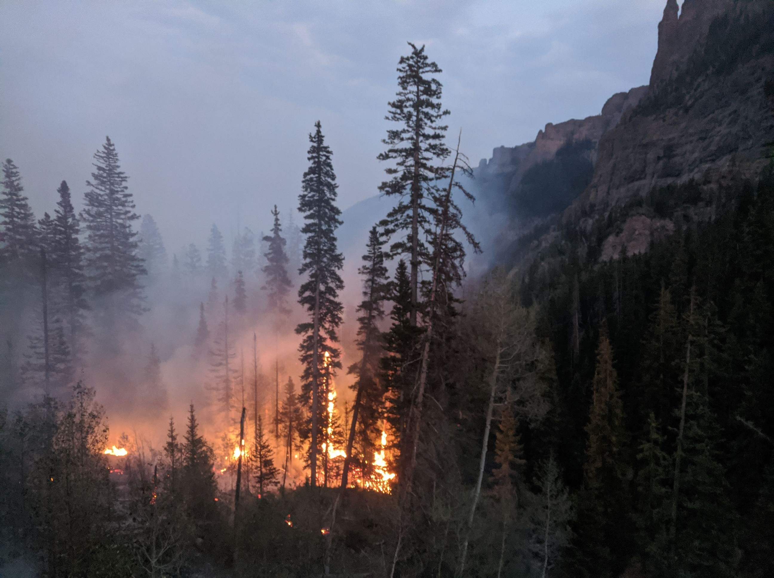 Wildfire burning through a mountain canyon